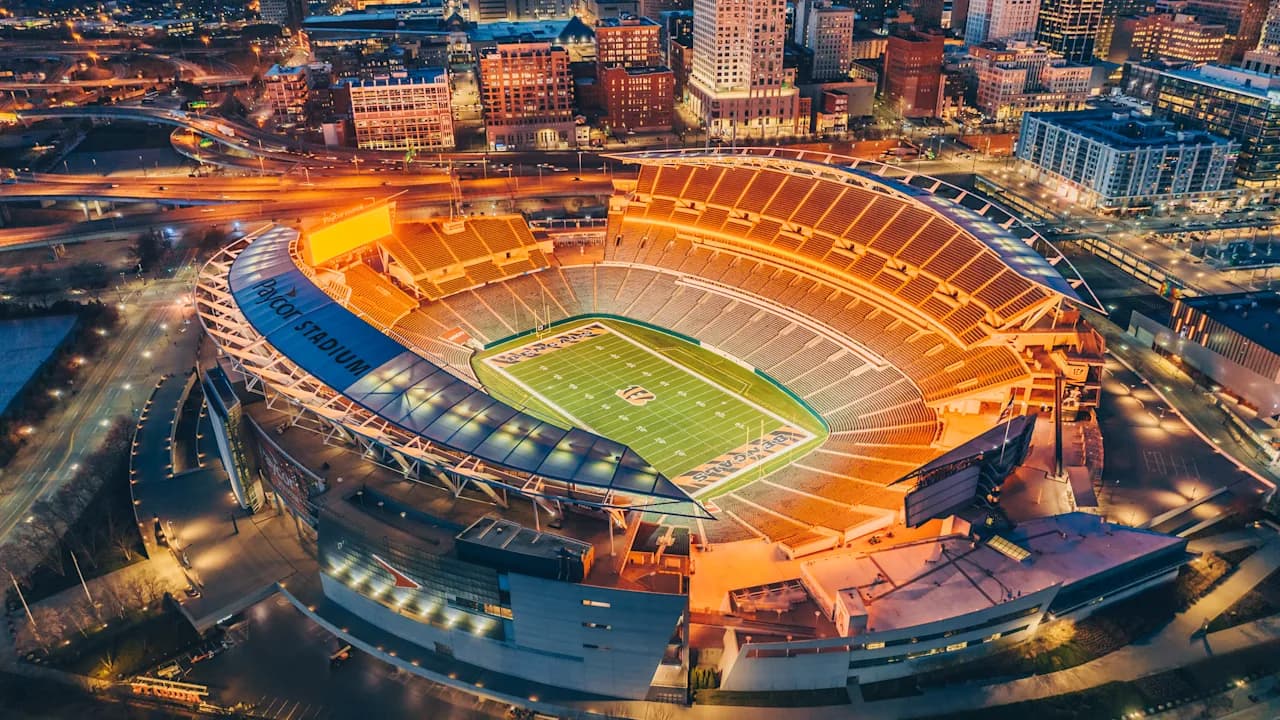 A general view of Paycor Stadium filled with Cincinnati Bengals fans on game day, orange and black throughout the bowl with the Ohio River and downtown Cincinnati beyond