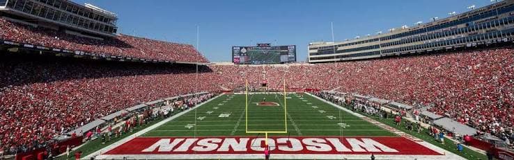 Camp Randall Stadium in full red on a clear Saturday — a sellout Wisconsin crowd with the WISCONSIN end zone front and center