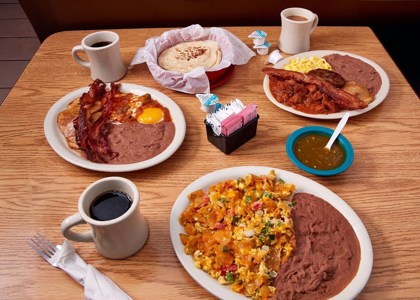 A Tex-Mex breakfast spread at Joe's Bakery & Coffee Shop — huevos rancheros, migas, tortillas, and coffee