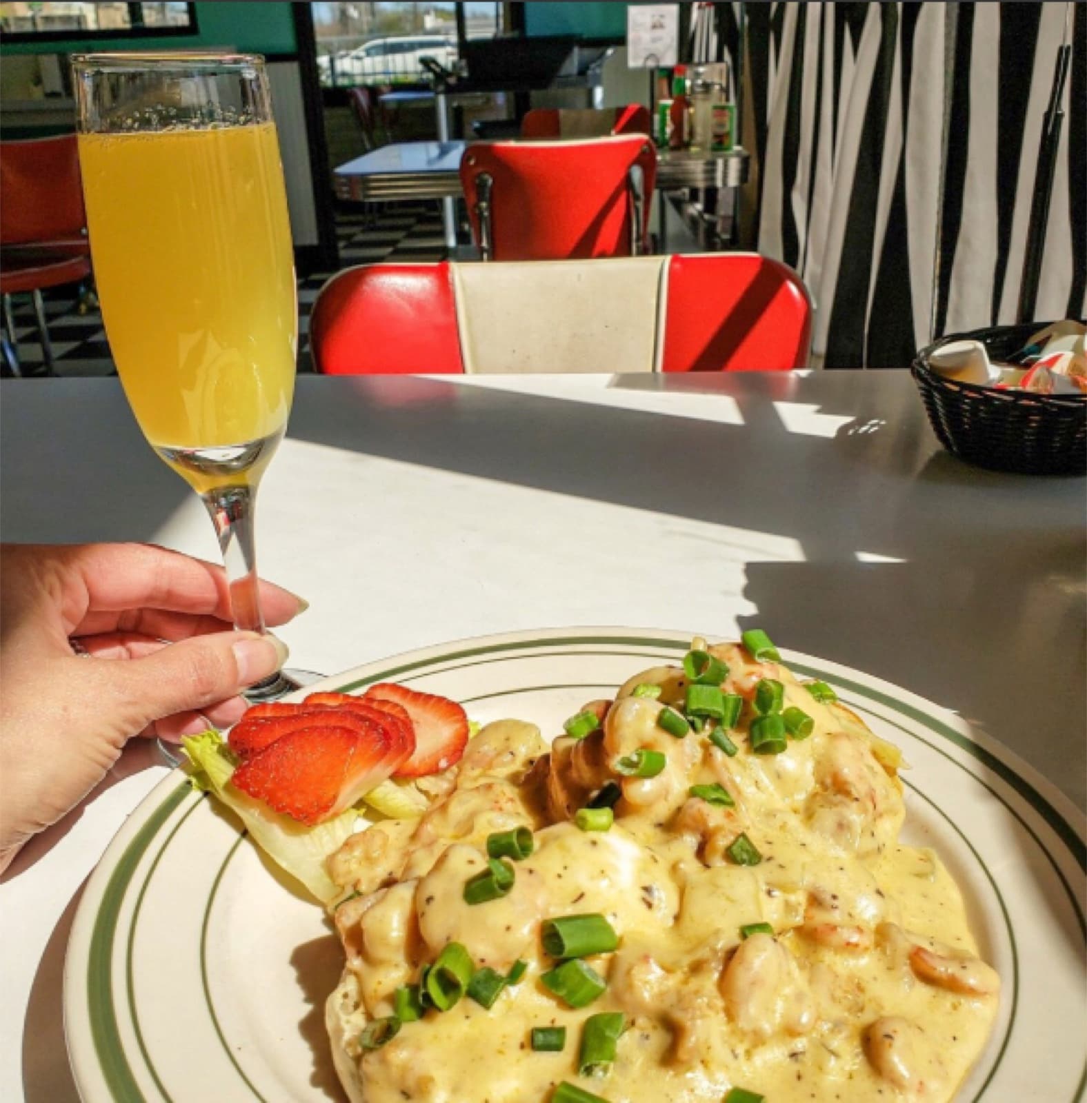 A crawfish étouffée omelet and mimosa at Louie's Café's red-vinyl diner counter