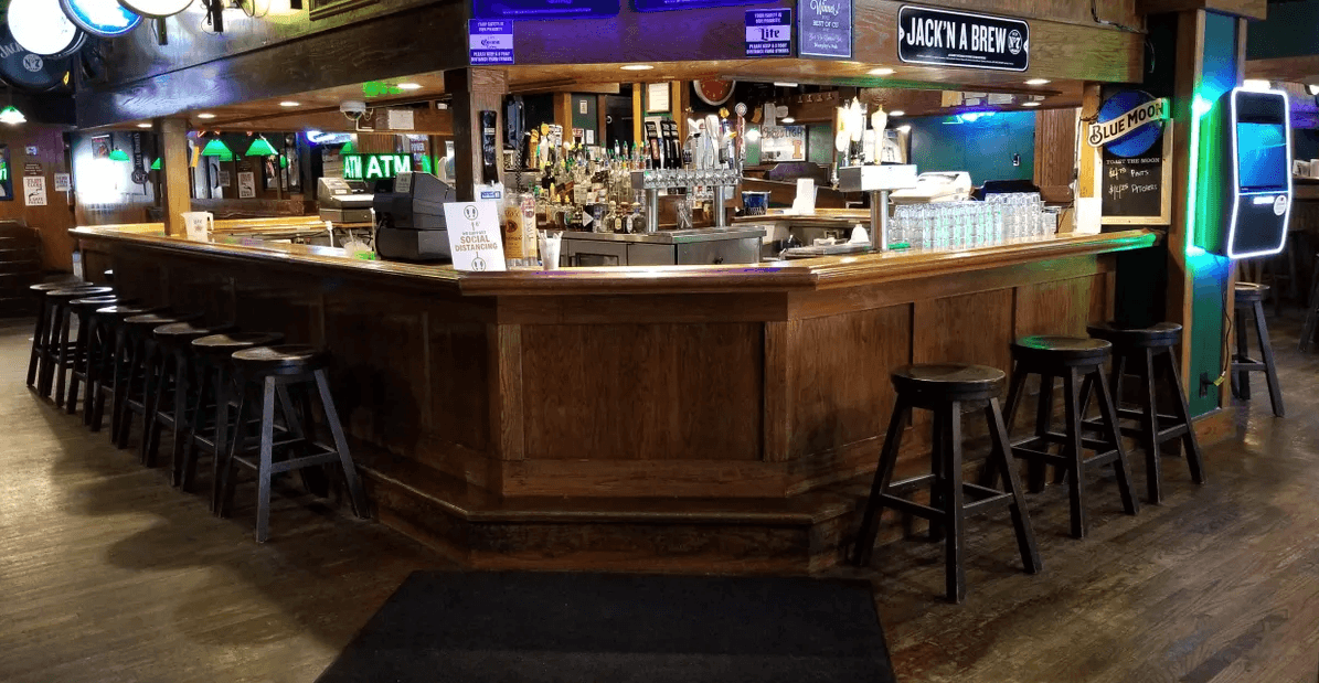 Murphy's Pub's wood-paneled barroom with taps lined along the counter and stools set along the bar