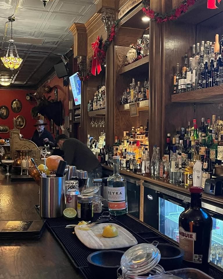 Shotgun Sue's ornate Old West back bar, fully stocked shelves and mounted trophy heads over the counter