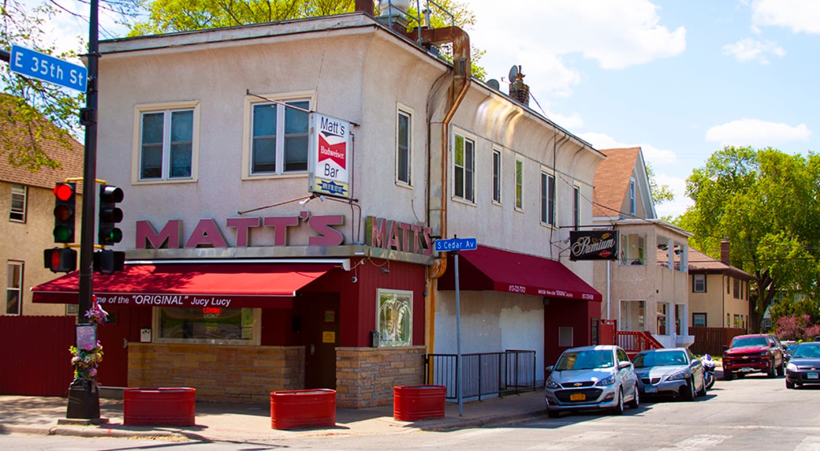 A straight-on view of Matt's Bar & Grill's storefront, 'Home of the ORIGINAL Jucy Lucy' on the red awning