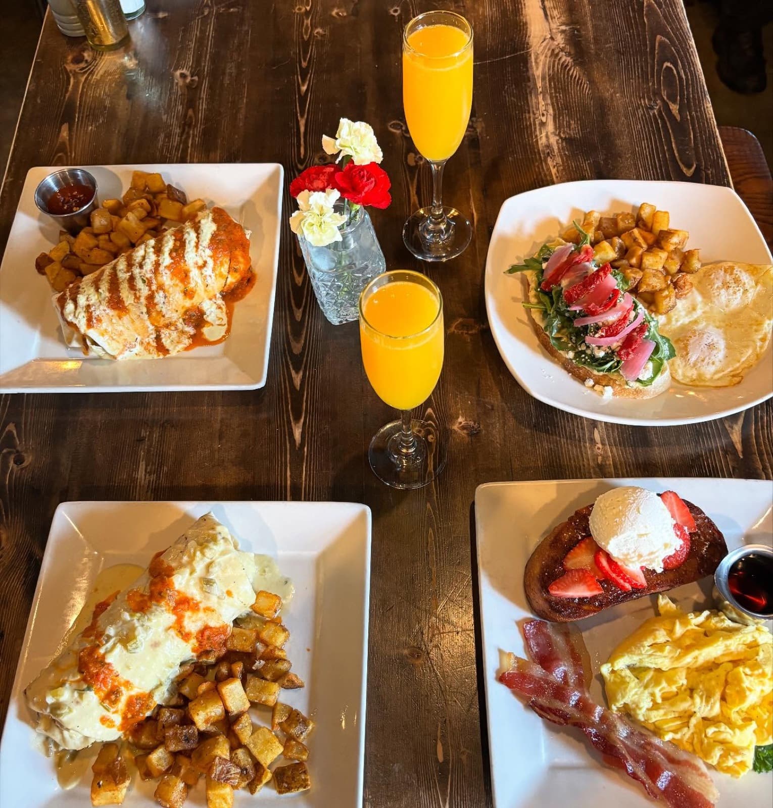 An overhead brunch spread at Scratch Kitchen & Cocktails — a chile relleno plate, breakfast tacos, and mimosas
