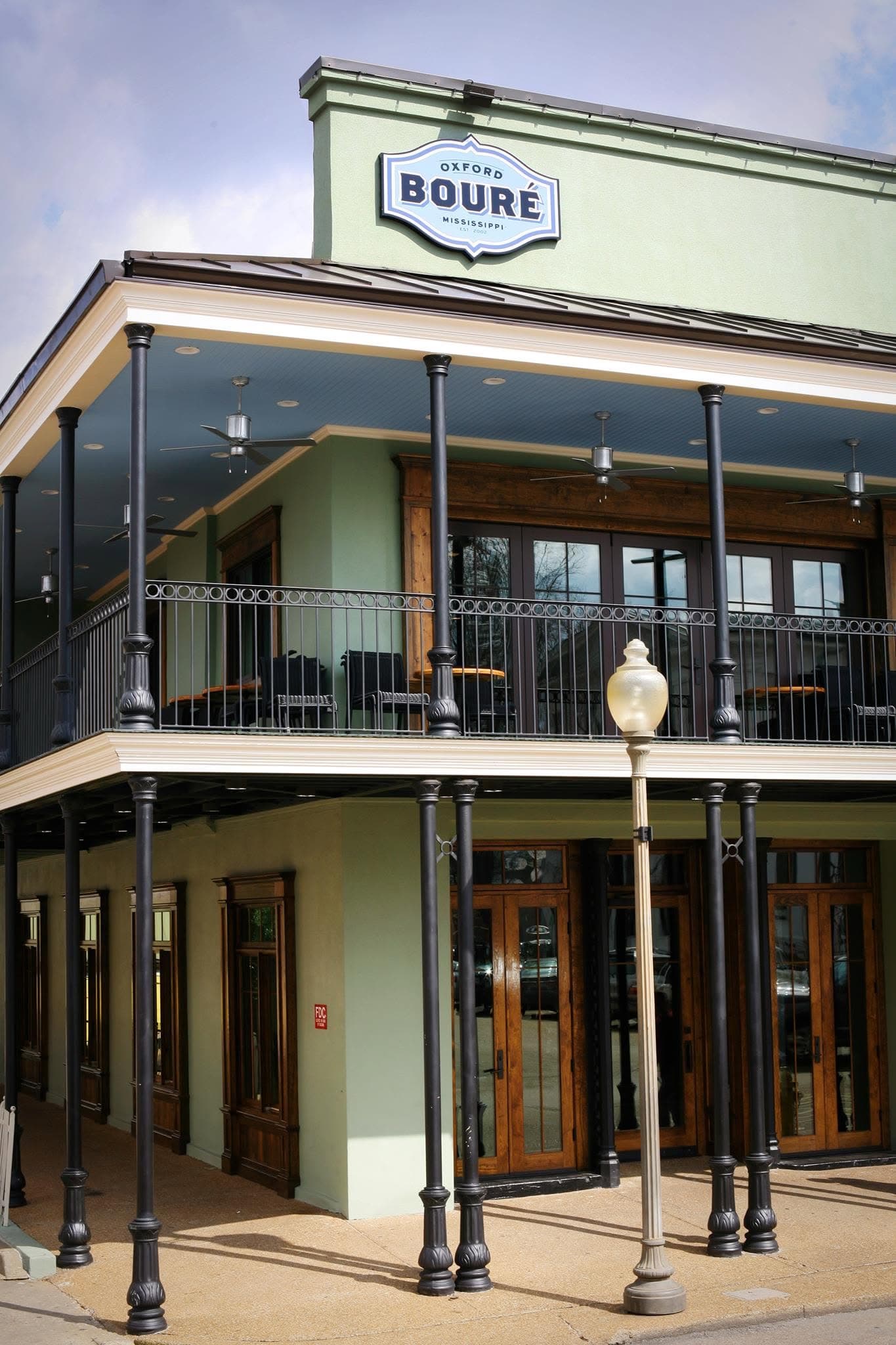 Bouré's green two-story balcony building with its Oxford Bouré sign above the Square