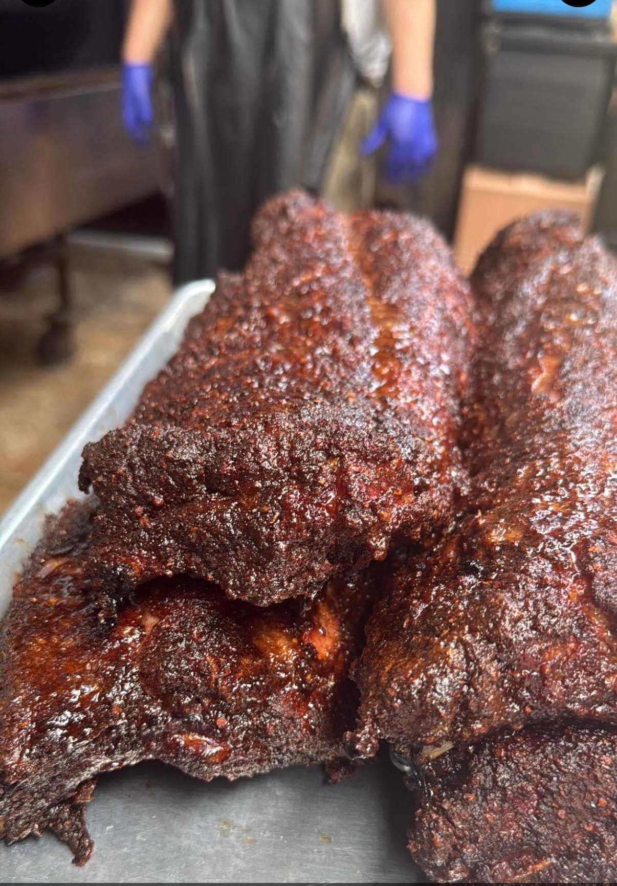 A tray of glazed, smoked pork ribs fresh off the smoker at The Little Dooey