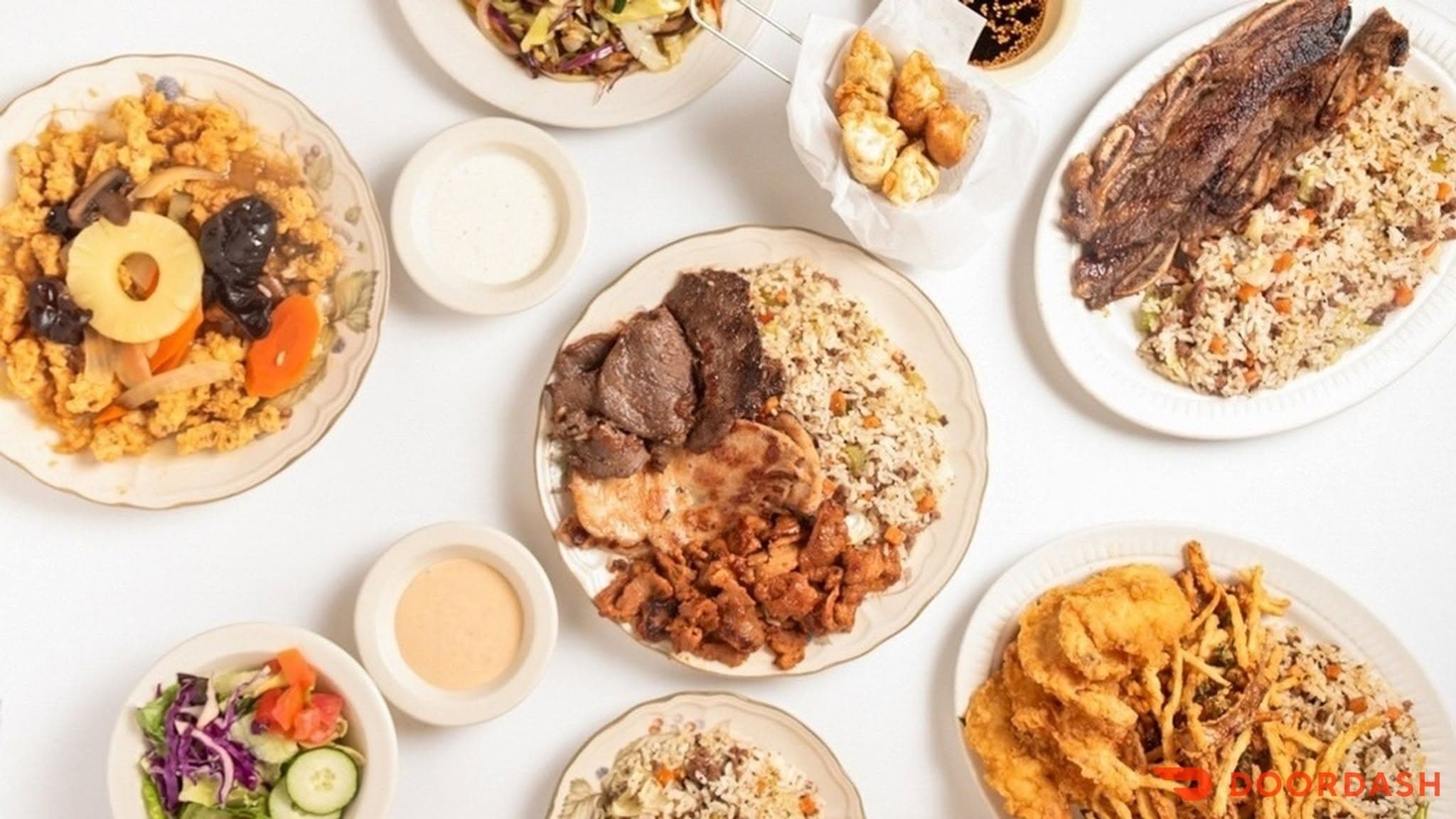 An overhead spread of Kitok Restaurant's Korean-diner plates — fried rice, bulgogi, fried chicken, dumplings, and sides